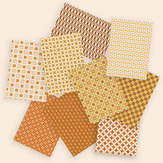 Collection of patterned paper sheets in brown and yellow tones on a beige background