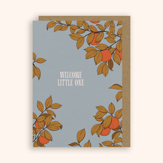 Greeting card with orange tree design and 'Welcome Little One' text on a light blue background