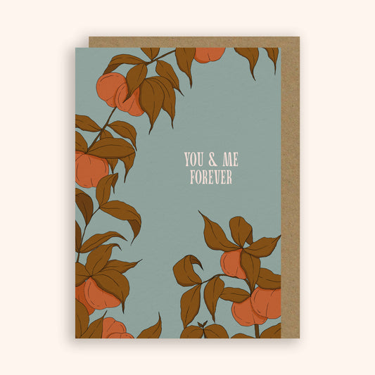 Greeting card with peach tree design and 'You & Me Forever' text on a light blue background