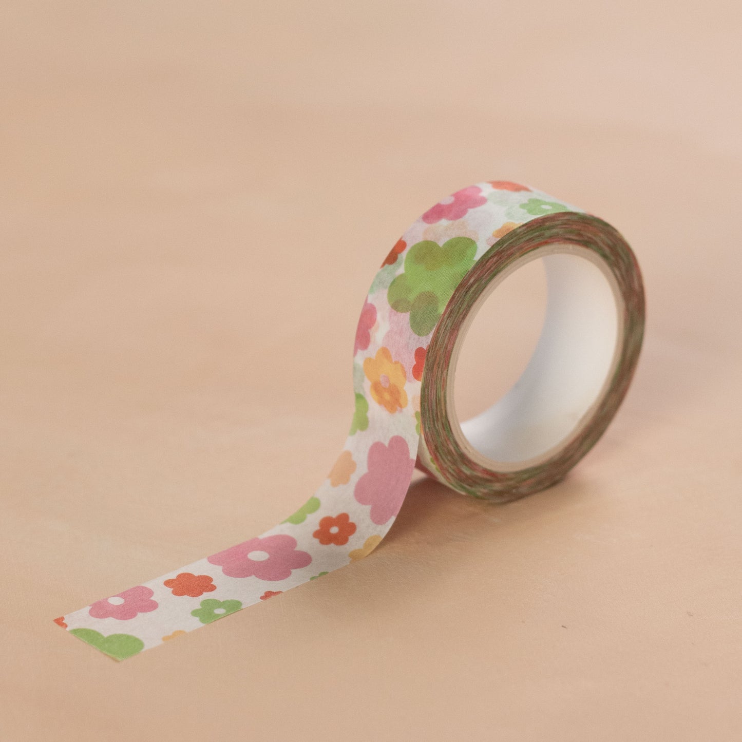 A graphic print floral washi tape on a beige background.